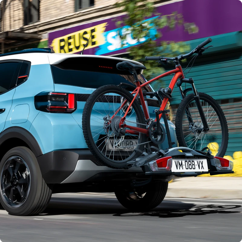 Widok z tyłu Citroëna C3 z bagażnikiem rowerowym na haku holowniczym ukazujący łatwy transport rowerów dla wygodnej, wszechstronnej i aktywnej mobilności na co dzień.