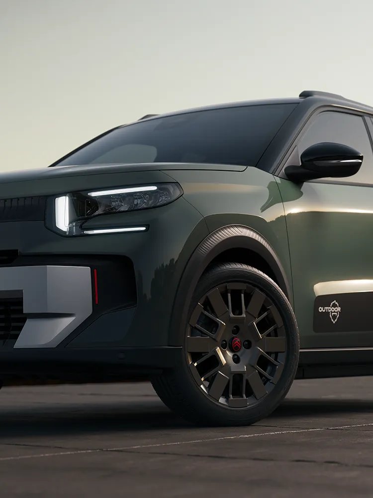 Zbliżenie na przednią część Citroëna ë-C3 Outdoor, aluminiową felgę i charakterystyczne światła LED, ukazujące komfort Advanced Comfort w kompaktowym SUV-ie