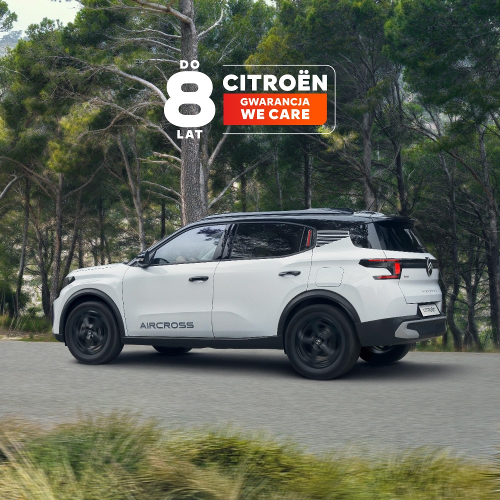 Widok z tyłu pod kątem 3/4 jazdy leśną drogą elektrycznego SUV-a Citroëna ë-C3 Aircross podkreślający nagradzany design oraz 8-letnią ochronę dla przystępnej mobilności.